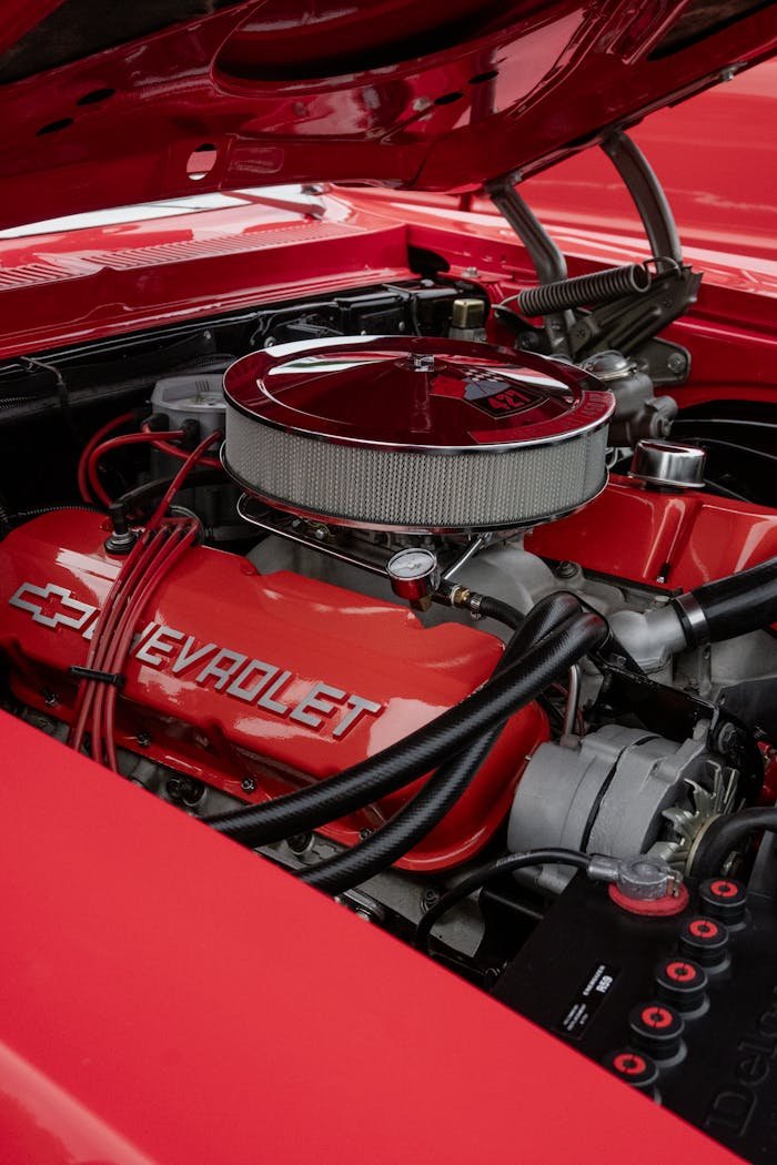 Detailed view of a classic Chevrolet engine at a car show in Alto, Michigan.